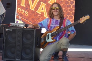 Bassist Caden Kramer, an endorsing artist for Genzler Amplification, poses with his bass guitar